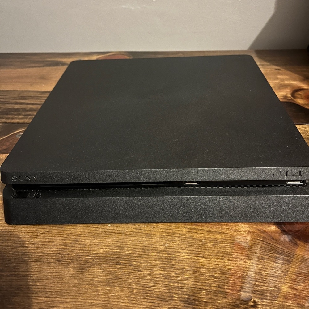 Gently used Sony PS4 slim with cords.
